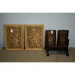 A pair of Chinese carved and pierced camphorwood panels,