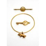 A yellow gold bangle, a brooch and a pendant