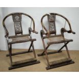 A pair of Chinese hardwood horseshoe-back folding chairs