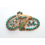 A turquoise and gold brooch,