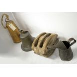 A N.E.R Railway pully or insulator, an oil jug, an 1842 dated farm bell, and a cowbell.