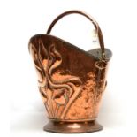 An Art Nouveau copper coal skuttle
