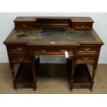 A late Victorian mahogany kneehole writing desk in the manner of Maple & Co,