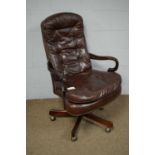 A Victorian style buttoned leather swivel and reclining desk chair