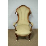 An ornate Victorian walnut open arm easy chair.