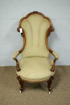 An ornate Victorian walnut open arm easy chair.