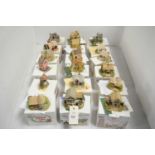 A collection of Lilliput Lane collectible cottages and other architectural sculptures.