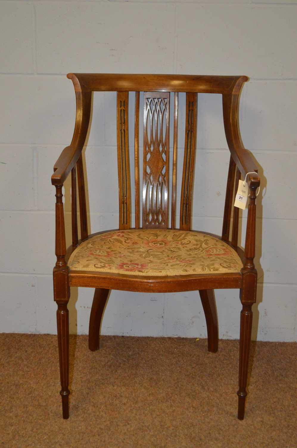 An Edwardian inlaid walnut tub armchair.