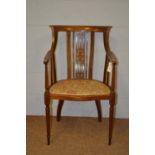 An Edwardian inlaid walnut tub armchair.