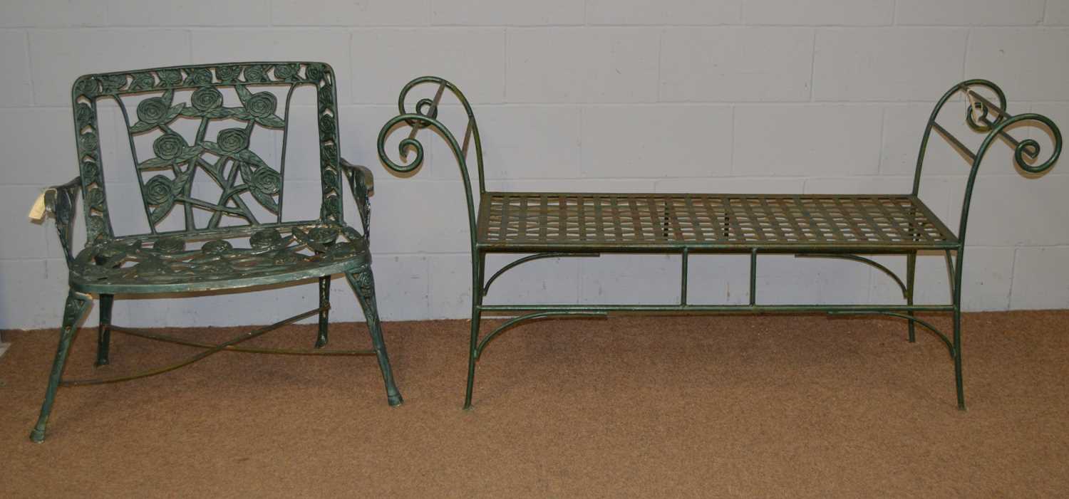 Two green painted cast iron garden benches.