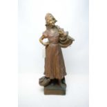 A bronzed spelter figure of a fisherwoman.