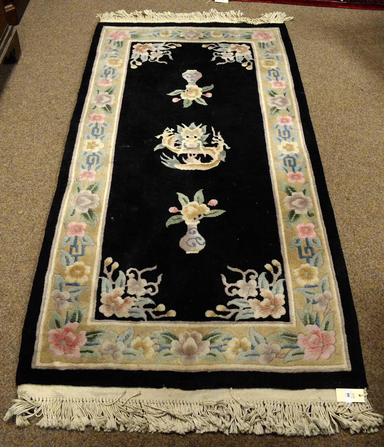 A Chinese wool bordered rug.