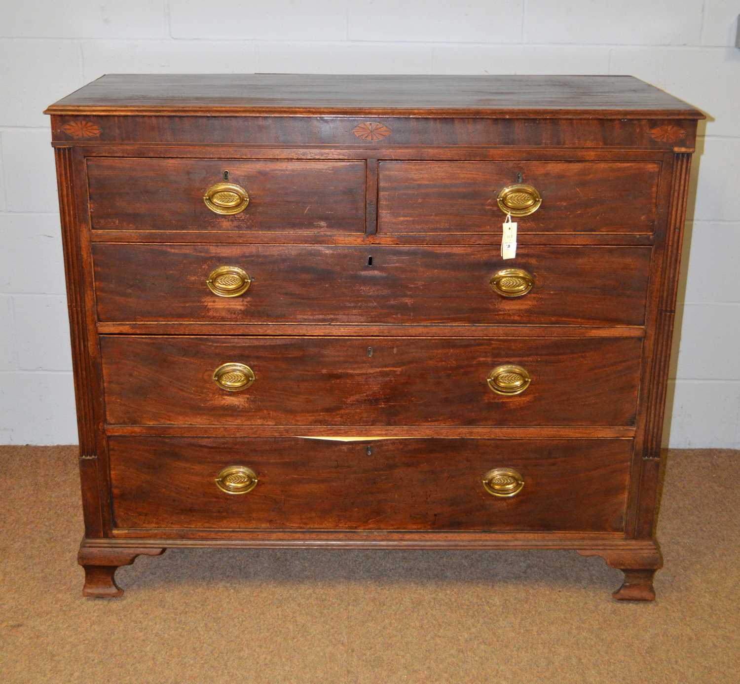 A Georgian inlaid mahogany chest of drawers.