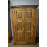 A carved cupboard in the 19th Century Anglo-Indian style