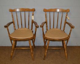 A pair of farmhouse kitchen carver chairs.