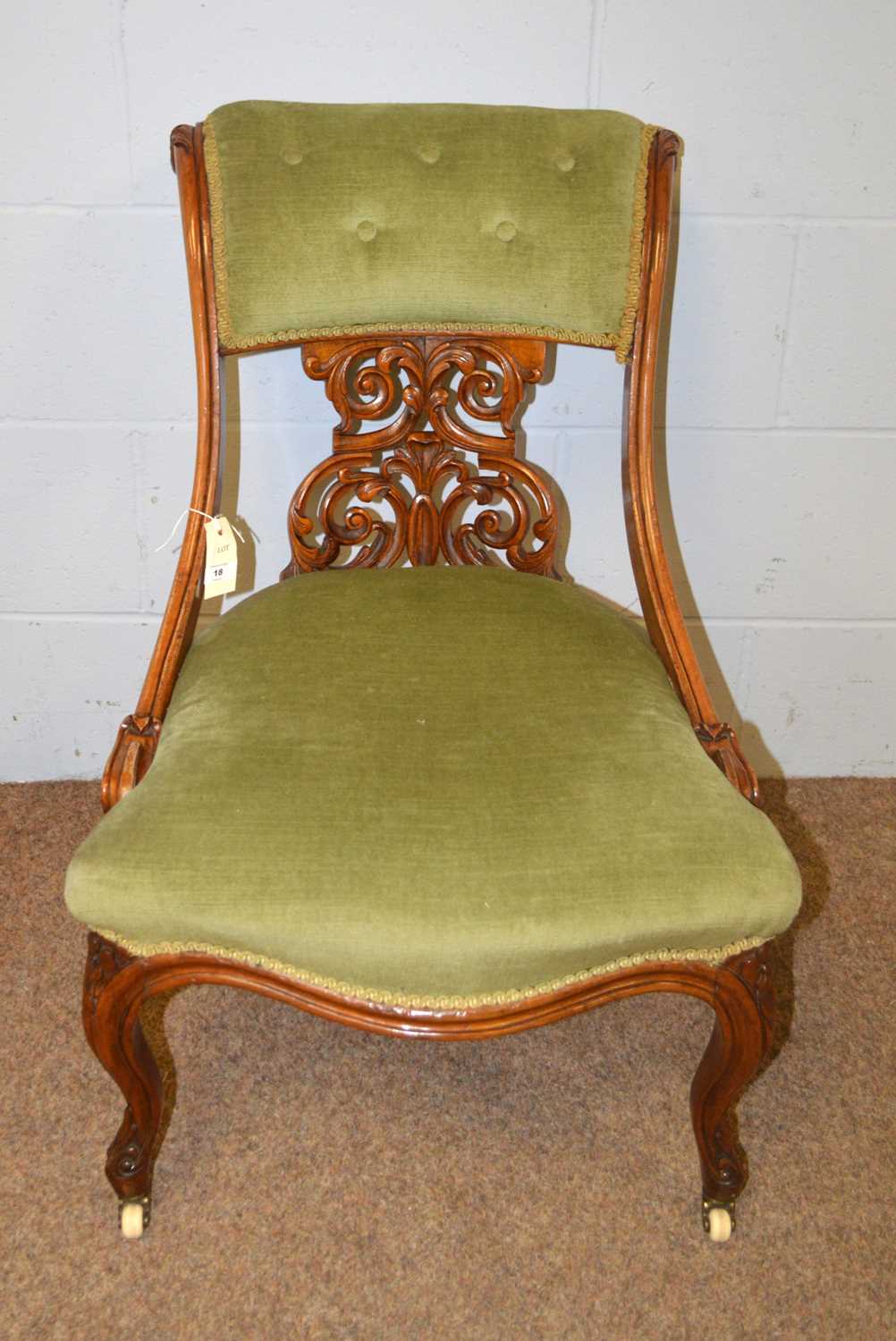 A Victorian walnut salon chair.