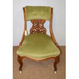 A Victorian walnut salon chair.