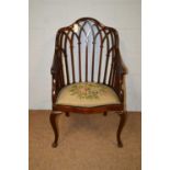 An Edwardian mahogany armchair.