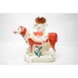 A Staffordshire cow spill vase.