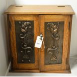 An Art Nouveau oak smokers cabinet.