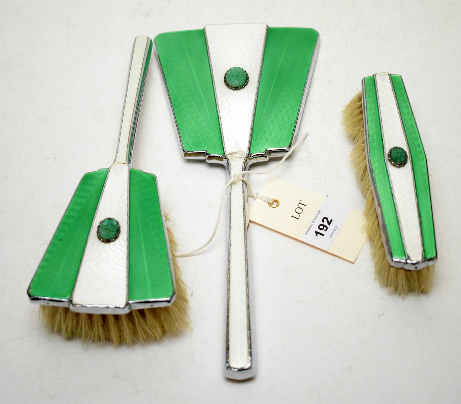 A white and green guilloche enamel three-piece dressing table set.