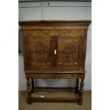 A large and ornate carved oak cupboard