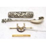 Silver spoon, brooch, gold sweetheart brooch and a tie pin