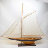 A stained and painted model pond yacht.