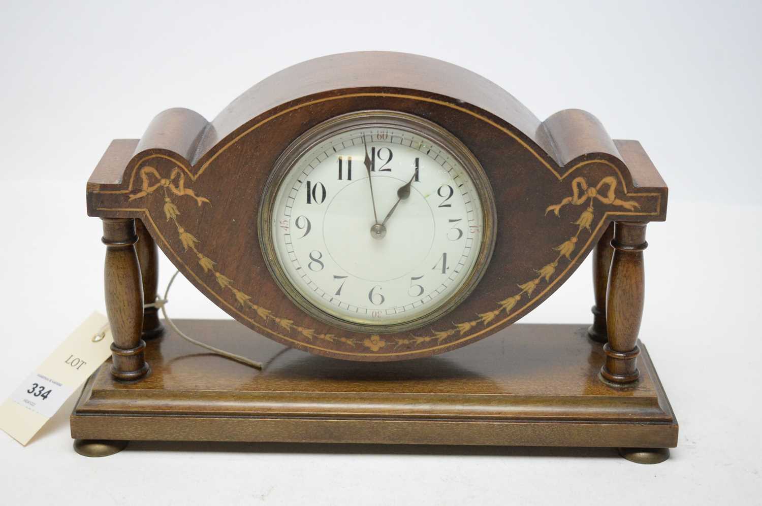 An Edwardian mahogany miniature mantel clock.