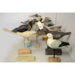 A collection of carved wood garden bird sculptures.