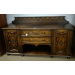 A 1930s carved oak sideboard.