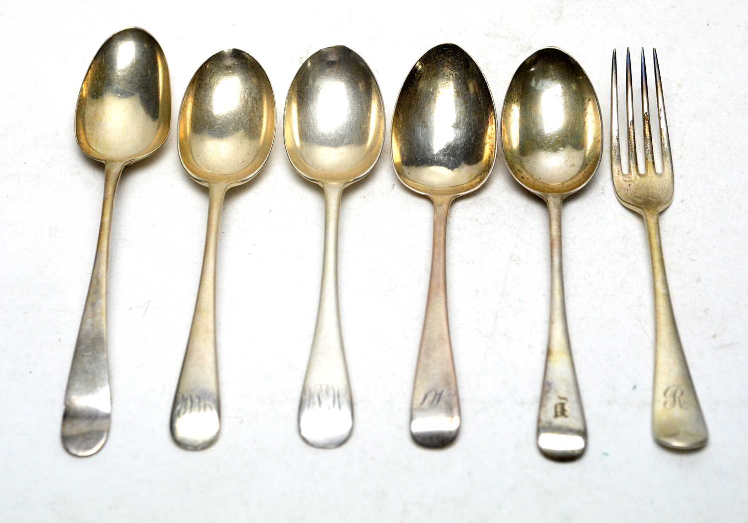 Five silver dessert spoons and a fork,