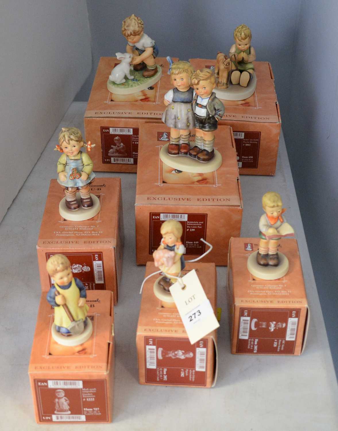 A collection of Goebel Hummel Club Exclusive Edition figures of children.