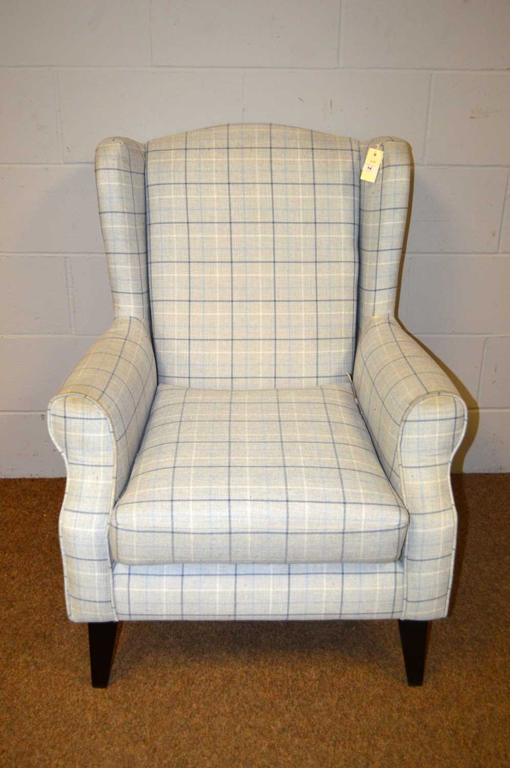 A 20th Century wingback armchair.