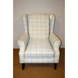 A 20th Century wingback armchair.