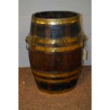 A late 19th/early 20th C oak brass bound barrel/stick stand.