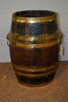 A late 19th/early 20th C oak brass bound barrel/stick stand.