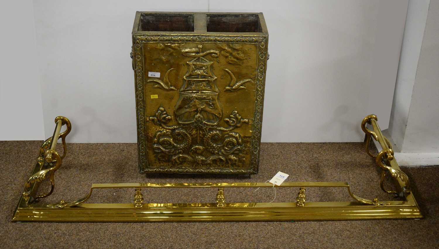 A Victorian brass fire fender, and a stick stand.