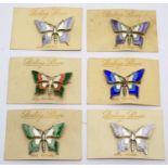 Six silver and enamel butterfly pattern brooches,
