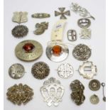 A selection of metal and silver coloured metal brooches,