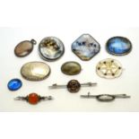A selection of silver and other brooches,