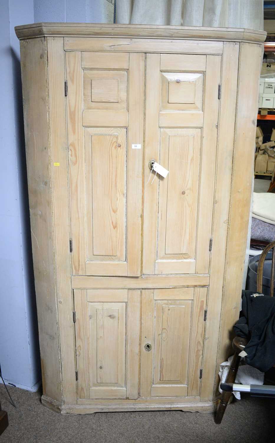 A 19th Century stripped pine floor standing corner cupboard.