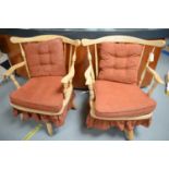 A pair of mid Century spindle-back swivel and reclining armchairs.