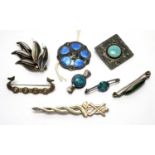 A selection of Arts and Crafts and other brooches and button.
