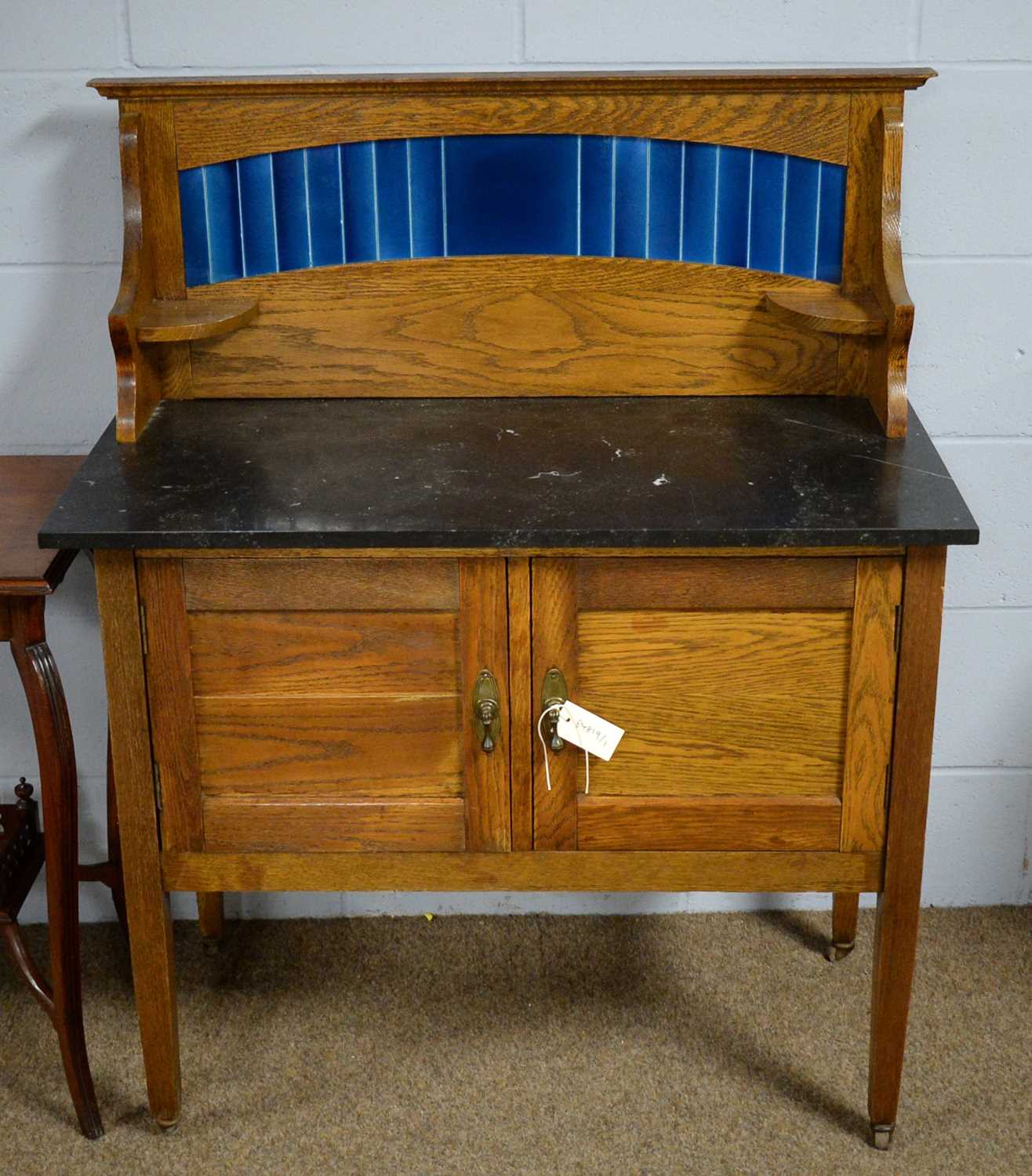 An Edwardian oak tile-back washstand.