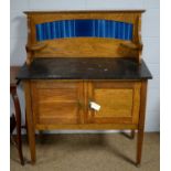 An Edwardian oak tile-back washstand.