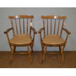 A pair of farmhouse kitchen carver chairs.