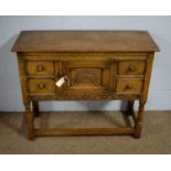 A mid 20th Century carved oak side cabinet.