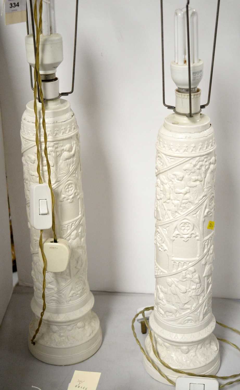 A pair of white painted table lamps.