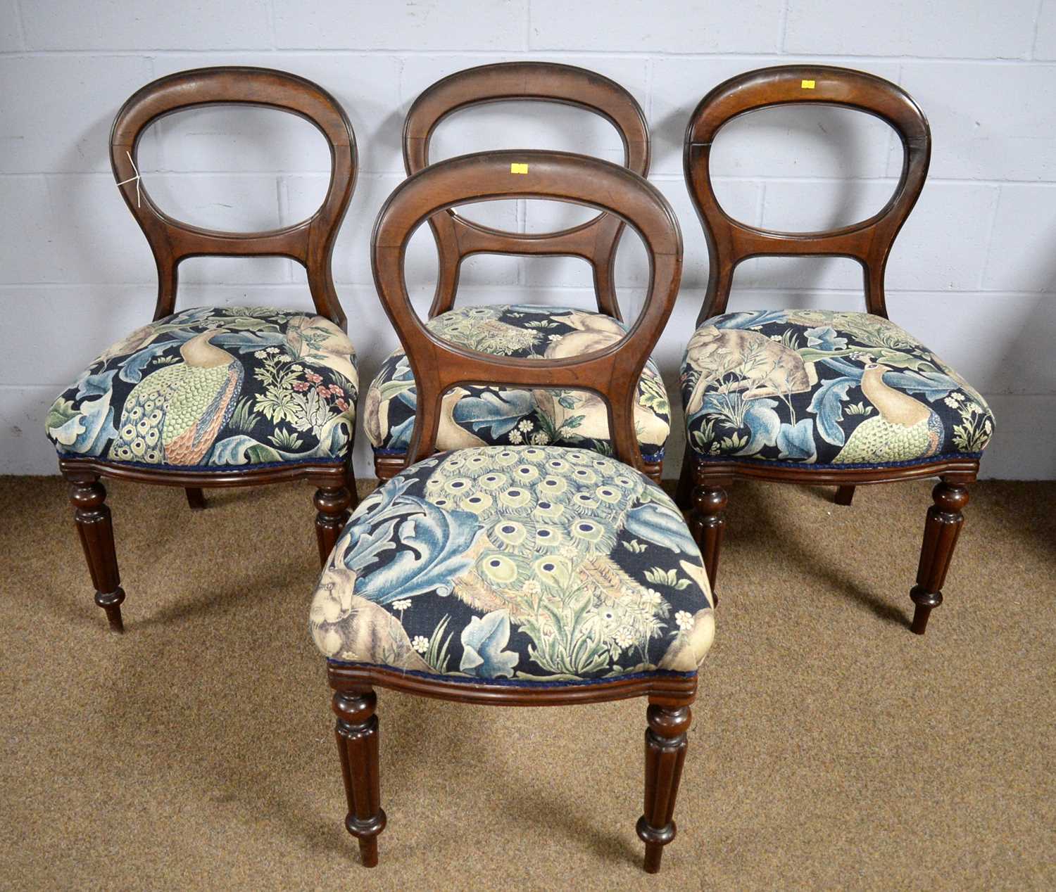 Four Victorian mahogany balloon-back dining chairs.